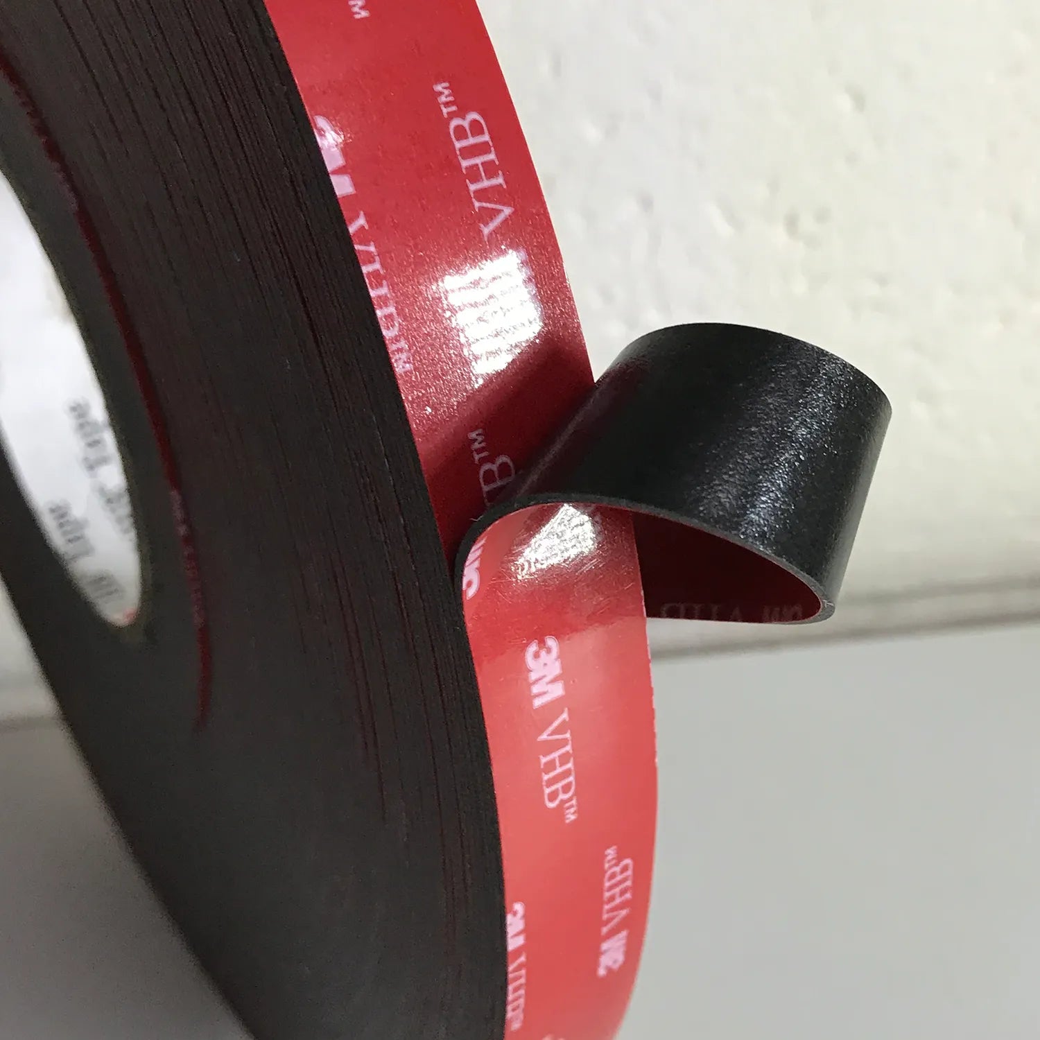 3M's 5952 VHB Tape is Black, 1mm thick, is designed for use on most plastics, works extremely well on LSE - Low Surface Energy Plastic surfaces