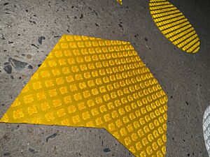 Custom Shape Road Marking Tape cut into Shapes, a Chevron shown here