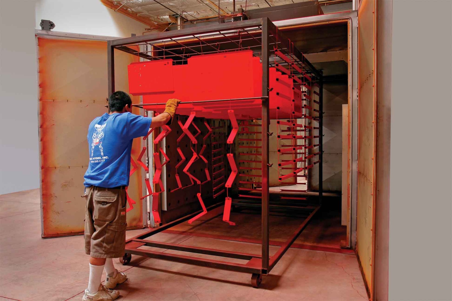 Products being powder coated in a powder coating oven